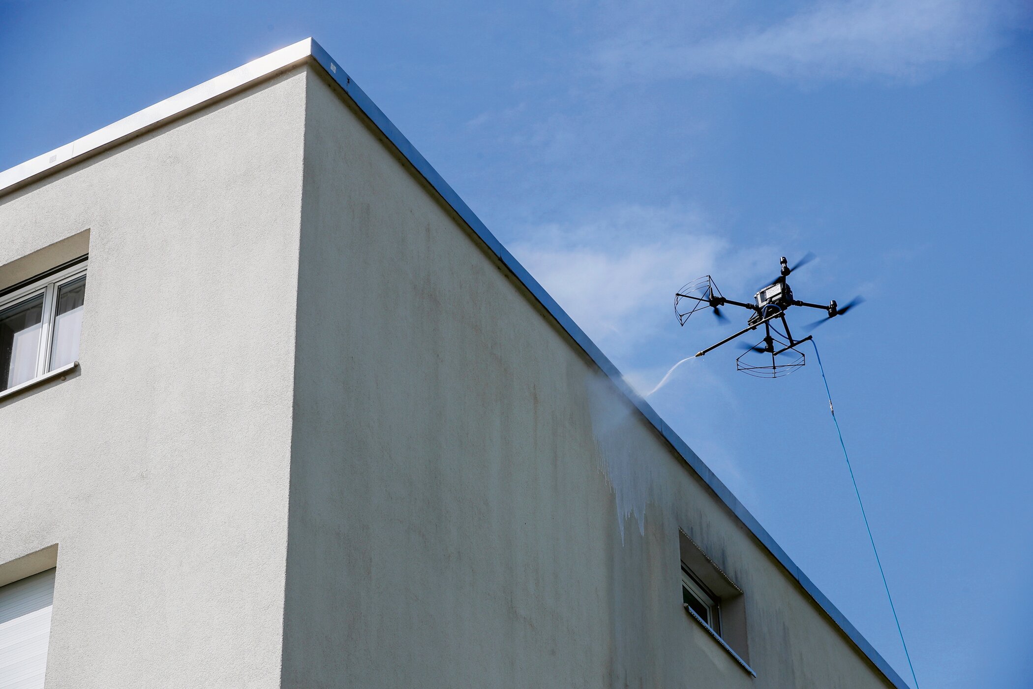 A drone washing a building facade